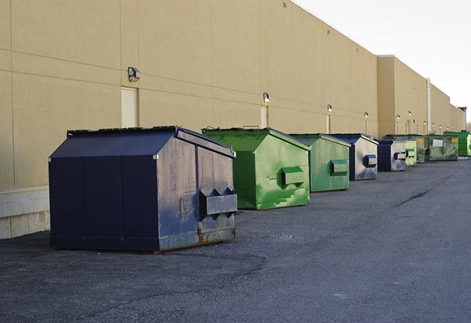 a red construction dumpster placed in front of a building under construction in Osceola